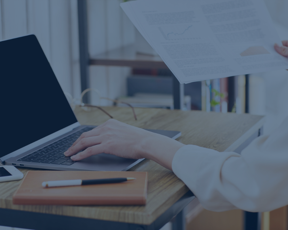 School system leader working at a laptop to submit the curriculum implementation phase.